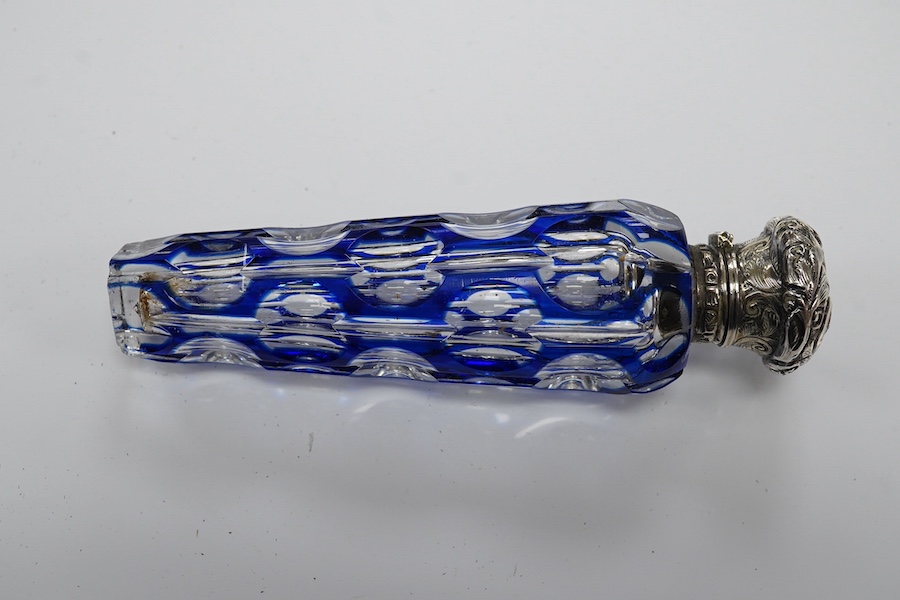 A 19th century silver topped blue overlay glass scent bottle, 11cm long. Condition - fine chips to base